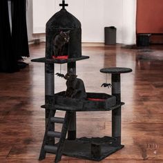 a black cat sitting on top of a tower in the middle of a living room