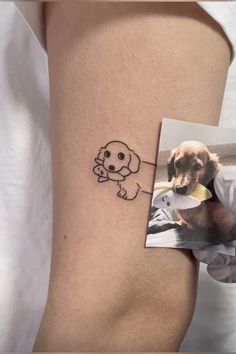 a dog with a bone in it's mouth is shown on the side of a woman's thigh