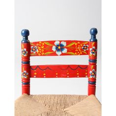 a wooden chair with painted flowers on it