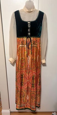 "AMAZING vintage dress from the 70's. No brand tag - only a \"dry clean only\" tag. Prairie dress style.  Maxi length. Zipper in back - eye hooks for collar and sleeve cuffs.  Sheer collar and sleeves.  Velvet bodice that laces up.  Polyester paisley skirt.  In Excellent Vintage Condition with some minor discoloration on sheer fabric Measurements: Bust: 35\" Waist: 30\" Length: 59\" Shoulders: 15\" Sleeve Length: 33\"" Vintage Long Sleeve Maxi Dress With Vintage Print, Retro Long Sleeve Vintage Evening Dress, Retro Long Sleeve Evening Vintage Dress, Vintage Long Sleeve Dress With Vintage Pattern, Vintage Formal Maxi Dress For Fall, Formal Vintage Maxi Dress For Fall, 1970s Vintage Print Fall Dresses, 1970s Long Sleeve Dresses With Vintage Pattern, 1970s Vintage Print Long Sleeve Dress