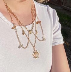 This piece was inspired by the solar eclipse from earlier this year. It features a radiant sun pendant at the center, with layered chains and crystals framing the neck and collarbone. Small stars and crescent moons are featured as a detail to the chains, and at the clasp falls a genuine vintage freshwater pearl, just at the end of the adjustable chain for added elegance.  This necklace took many hours to design and assemble with care. Additionally, all materials used were nickel-free. Bohemian Gold Necklace With Moon Charm, Handmade Gold Goddess Necklaces, Handmade Gold Goddess Necklace, Handmade Goddess Style Gold Necklace, Handmade Ethereal Dangle Jewelry, Ethereal Handmade Dangle Jewelry, Ethereal Gold Dangle Jewelry, Bohemian Jewelry With Dangle Moon Charm, Celestial Sun And Moon Dangle Jewelry