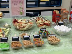 a table topped with lots of different types of food and desserts on top of it