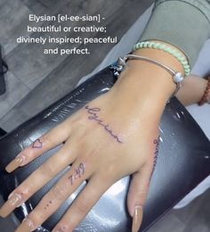 a woman's hand with her name tattooed on it and the words, eysian lee - san beautiful or creatively inspired, divinely inspired, peaceful and perfect