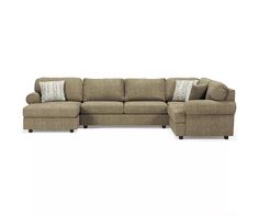 a large sectional couch with pillows on the top and bottom corner, in front of a white background