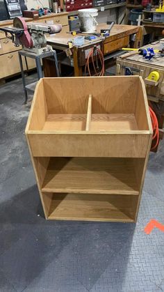 an unfinished wooden shelf in a workshop