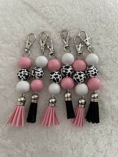 four tasseled key chains with black, white and pink beads