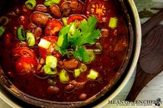 a bowl filled with beans and vegetables on top of a table