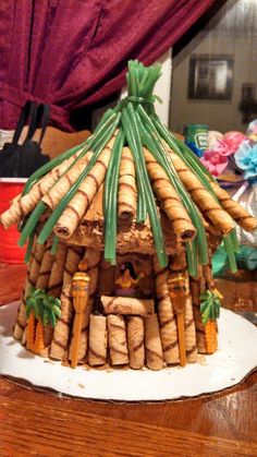 a house made out of wine corks sitting on top of a wooden table