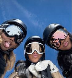 three women wearing ski goggles and snowboarding gear are posing for the camera with their mouths open