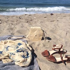 a pair of sandals and a bag on the beach