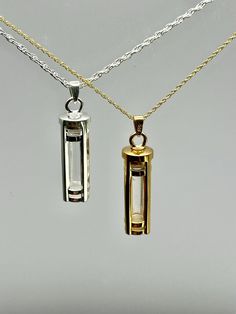 This beautiful cremation cylinder with glass to allow you to view the contents is a unique way to hold a loved one close. This pendant can hold a small amount of cremains, lock of hair, or dirt from the sacred burial grounds. This piece comes on an 18" matching chain. GOOD TO KNOW: ♥ Available in Sterling Silver and 14K Plated Gold ♥THIS PENDANT CAN NOT BE ENGRAVED ♥Fill kit included with pendant CARE: ♥Both 14k plated gold and Sterling Silver are resistant to rust, corrosion, and tarnishing, but we still recommend for the longevity of the pendant to remove prior to swimming or bathing PACKAGING: ♥The pendant comes in a small jewelry box that can easily be used for gifting ♥We can also ship directly to the recipient, just be sure to use their address in the shipping section at checkout SHI Resin Necklace With Ashes, Lock Of Hair, Urn Jewelry, Urn Necklace, Cremation Ashes, Hair Locks, Urn Necklaces, Small Jewelry Box, Cremation Jewelry