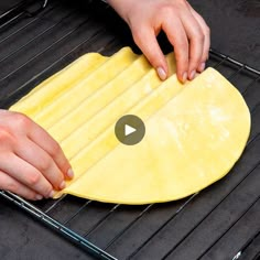 a person is rolling out dough on top of an oven rack to make tortilla bread