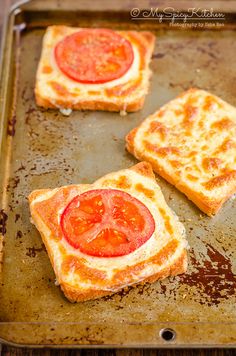 four slices of toast with tomatoes on them