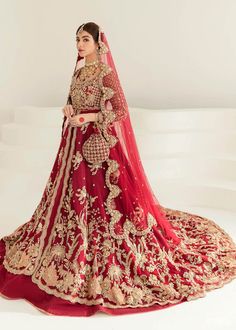 a woman in a red and gold bridal gown