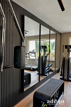 an exercise room with mirrors and treadmills