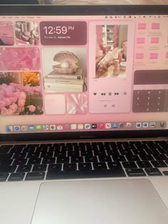 an open laptop computer sitting on top of a white table next to a pink flower vase