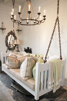 a white baby crib in a room with chandelier hanging from the ceiling