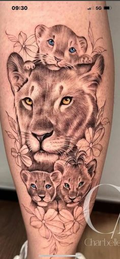 a woman's thigh with an image of a lion and two cubs on it