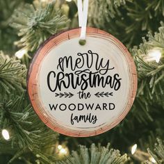 a wooden ornament hanging from a christmas tree with the words merry christmas the woodyard family