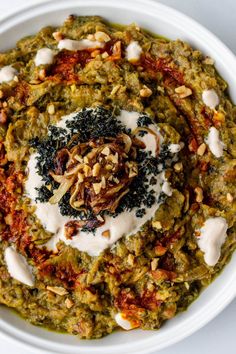 a white bowl filled with food on top of a table