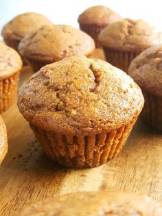 some muffins are sitting on a wooden table