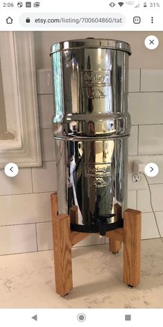 a large metal pot sitting on top of a wooden stand