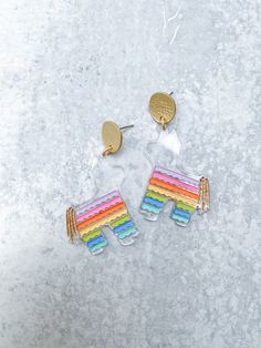 These pinata earrings will make ANY outfit more festive! Get ready to celebrate Cinco de Mayo in style. Everyone is going to ask where you got these fun earrings! Made from lightweight acrylic. Available in 2 options: Clear Acrylic with a Rainbow of Colors Iridescent Acrylic They hang from matte gold 18k gold plated coin studs with a stainless steel earring post. Customers with sensitive ears always tell us that our earrings are great! Fun Multicolor Earrings For Birthday, Fun Plastic Jewelry For Party, Playful Multicolor Earrings For Birthday, Fun Plastic Party Jewelry, Novelty Multicolor Earrings For Birthday, Plastic Drop Earrings For Party, White Plastic Earrings For Parties, Cute Multicolor Plastic Earrings, Cute Plastic Party Earrings