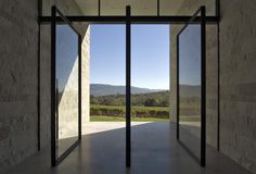 an open door leading into a large room with mountains in the background