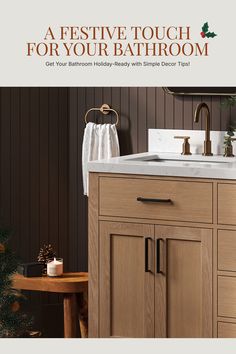 a bathroom sink sitting under a mirror next to a wooden cabinet and christmas tree in the corner