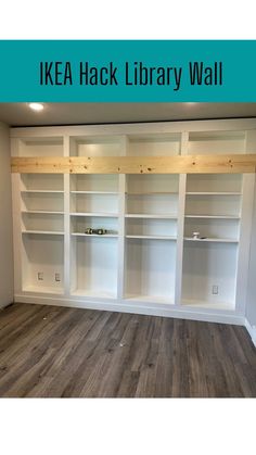 an ikea hack library wall with white bookcases