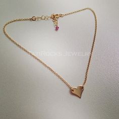 "Lovely single heart anklet. All HIGH QUALITY gold filled and with a tiny genuine Pink Sapphire at the extension. Anklet measures 9.5\" to 10.5\". Please notify if me if this needs to be customized. All 14k gold filled (will not fade, tarnish, turn colors). Personalize the anklet with a single letter. Please leave me the letter in the NOTES section at checkout. Also available in all Sterling Silver and ALL 14K Rose Gold Filled This is a HIGH QUALITY Anklet made with a All gold filled heart and H Heart-shaped Anklets For Valentine's Day, Adjustable Heart-shaped Anklets For Valentine's Day, Adjustable Heart Charm Anklets, Gold Heart Anklets, Dainty Adjustable Anklets For Valentine's Day, Dainty Anklets With Heart Charm For Gifts, Dainty Anklet With Heart Charm As Gift, Dainty Heart-shaped Anklet For Gift, Dainty Heart-shaped Anklet As Gift