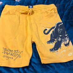 New Ed Hardy Cotton Shorts With Drawstring, Side Pockets And Back Pockets. Original Tags Attached And Never Worn. Yellow Bottoms With Elastic Waistband For Streetwear, Yellow Relaxed Fit Bottoms For Streetwear, Yellow Pocket Shorts For Streetwear, Yellow Streetwear Shorts With Pockets, Yellow Shorts With Pockets For Streetwear, Yellow Leisure Bottoms For Summer, Casual Yellow Shorts For Leisure, Fitted Yellow Shorts For Loungewear, Yellow Cotton Shorts For Streetwear