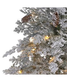 a white christmas tree with pine cones and lights