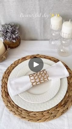 a table setting with white plates and napkins