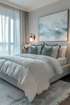 Transform Your Bedroom: Modern Elegance with a Touch of Blue and Grey Master Bedrooms Decor White Bed, Modern Bedroom White And Grey, Grey Bed Blue Bedding, Grey Bed With White Bedding, Blue And Grey Home Decor, Grey And White Apartment Aesthetic, 10 By 13 Bedroom Ideas, White Blue And Grey Bedroom, Large Artwork Over Bed