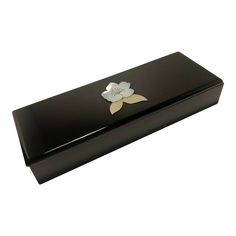 a black box with a flower on the lid