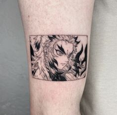 a man with a tattoo on his arm that has an anime character in the center