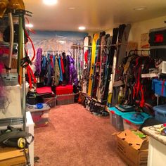 a room filled with lots of skis and snowboards