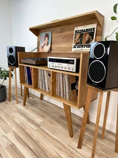 an old record player and stereo system in a room with wooden floors, white walls and wood flooring