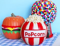 two pumpkins with the word popcorn painted on them