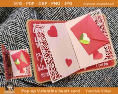 valentine's day card with envelopes and hearts cut out of paper on top