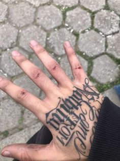 a person's hand with tattoos on it