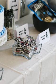 a table topped with lots of different types of candies and cake slices on top of it