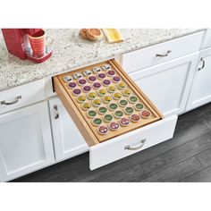 an open drawer in the middle of a kitchen