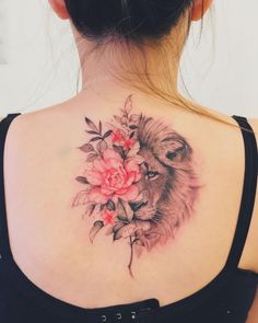 a woman with a lion and flowers tattoo on her back