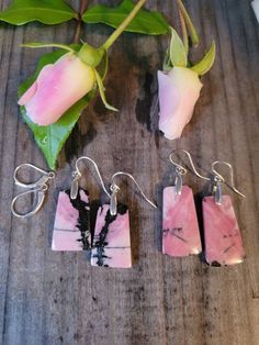 These are pairs of a very pretty pink Rhodonite drop earrings. Each pair is handmade. The drop from earlobe is an inch and a half. The colors include shades of rose pink with black veining. The bales and hooks are Sterling Silver. Both fishhooks and leverbacks are available. Pink Hypoallergenic Drop Jewelry, Pink Drop Earrings With Ear Wire, Handmade Pink Drop Jewelry, Pink Pierced Earrings As Gift, Unique Pink Sterling Silver Earrings, Unique Pink Teardrop Jewelry, Unique Nickel-free Pink Earrings, Unique Nickel Free Pink Earrings, Pink Dangle Earrings For Gift