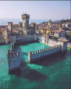 an aerial view of a castle in the water