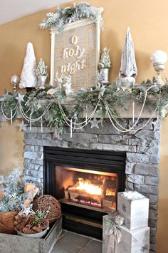 a fireplace decorated for christmas with stockings and garland