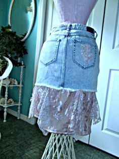 "This \"Belle Bohémienne\" jean skirt is one of my line of Renaissance Denim Couture, the name I chose for my line of couture because I take vintage denim and give it new life with French bohemian flair. To make this Renaissance Denim couture creation, I took a jean skirt with embroidered pink roses and upcycled it by adding layers of ruffled pimk champagne satin and vintage French lace in two different shades of gorgeous mauve pink and rose hues. I used a soft pink rose antique French lace that Fitted Pink Denim Skirt, Fitted Denim Skirt In Pink, Pink Fitted Denim Skirt, Fitted Denim Bottoms With Lace Trim, Spring Bohemian Denim Skirt With Frayed Hem, Bohemian Spring Denim Skirt With Frayed Hem, Bohemian Denim Skirt With Frayed Hem For Spring, Bohemian Summer Denim Skirt With Frayed Hem, Summer Bohemian Denim Skirt With Frayed Hem