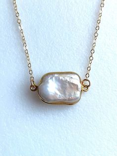 Large white freshwater pearl surrounded with 24k gold vermeil bezel on dainty 14k gold fill necklace. Stunning flat white pearl bezel is 22 x 12 mm with lots of shimmering luminescence. Flat White, June Birthstone, White Freshwater Pearl, White Flats, Choker Necklaces, June Birth Stone, White Pearl, Large White, Pearl White